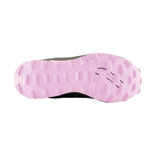 Trail shoe outsole with pink lugged tread and black upper visible at the edges