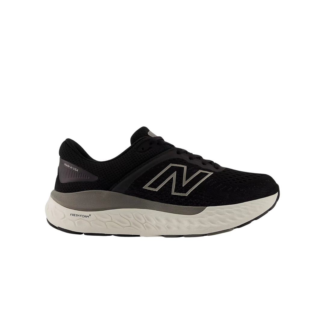 Black running shoe with gray midsole and large side logo
