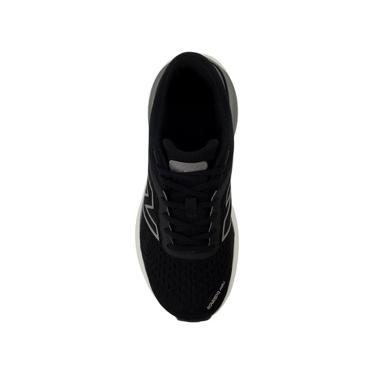 Black running shoe seen from above with white side accents and a thick foam sole