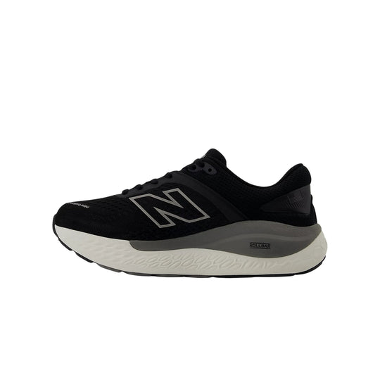 Black New Balance running shoe with gray midsole and white outsole, side view