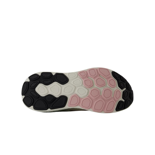 Shoe outsole with black, white, and pink tread pads