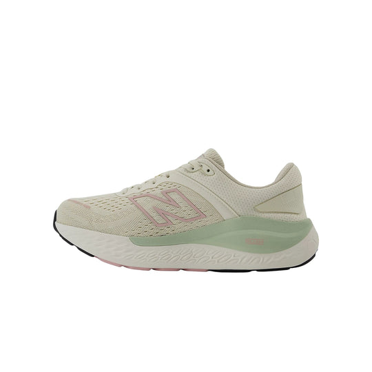 Light beige running shoe with pink side logo and mint green midsole, side view