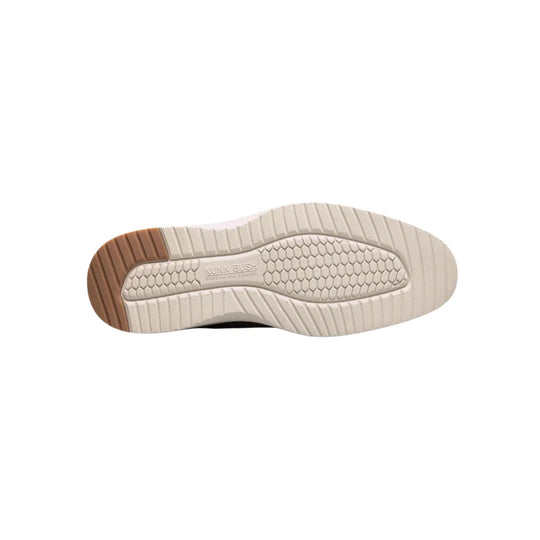 Beige sneaker outsole with brown heel tread and textured traction pattern