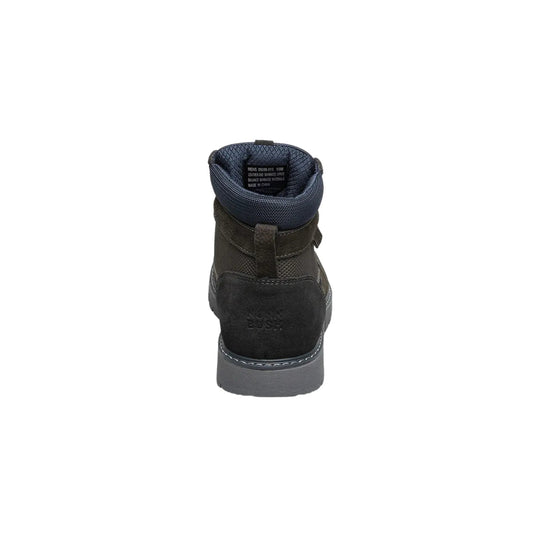 Rear view of a dark ankle boot with a padded blue collar and gray sole