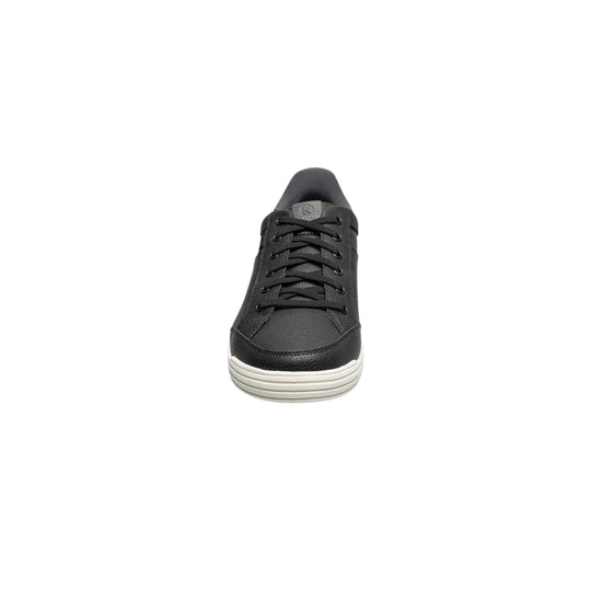 Black lace-up sneaker with a white ribbed sole and logo tag on the tongue