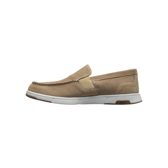Beige suede slip-on loafer with moc toe, white sole, and brown heel accent