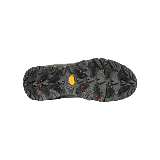 Black rugged boot outsole with deep traction lugs and a yellow Vibram label