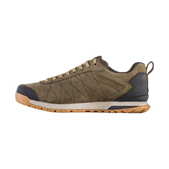 Brown suede low-top hiking shoe with tan laces, black toe cap, and gum rubber sole