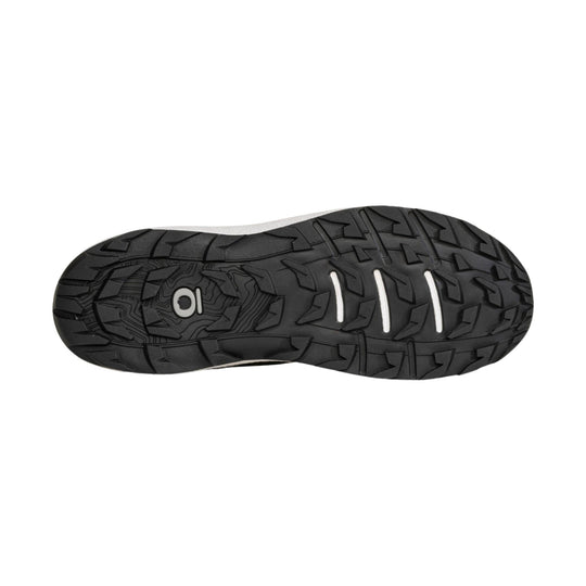 Black rugged hiking shoe outsole with deep traction lugs and three white flex grooves