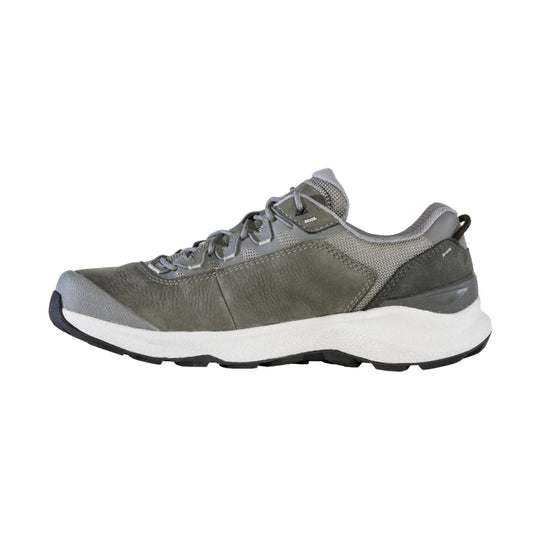 Gray low-top hiking shoe with leather and mesh upper, white cushioned sole, and black toe cap