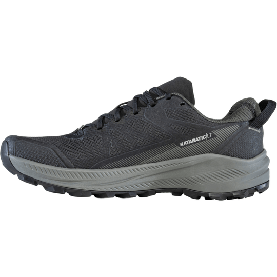 Black low-top hiking shoe with grey midsole and lugged outsole, shown in side profile