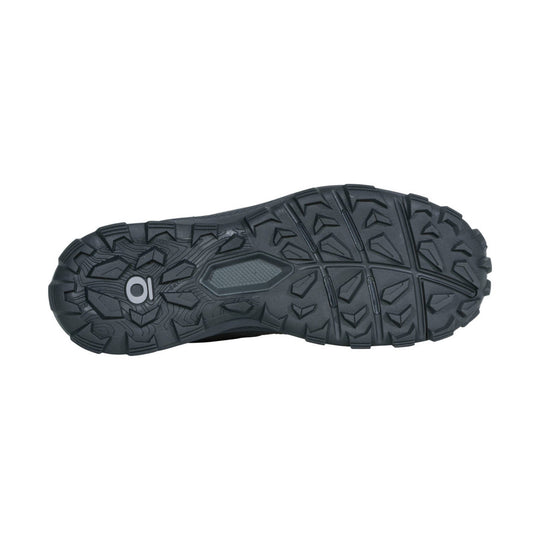 Black hiking boot outsole with deep tread and a logo near the heel