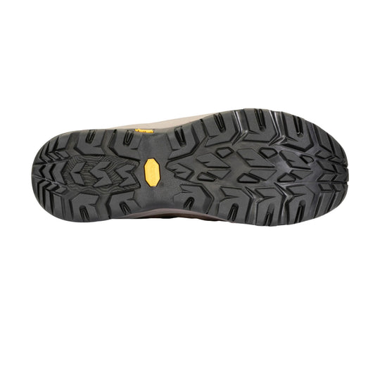Black hiking boot outsole with deep lug tread and a yellow Vibram insert