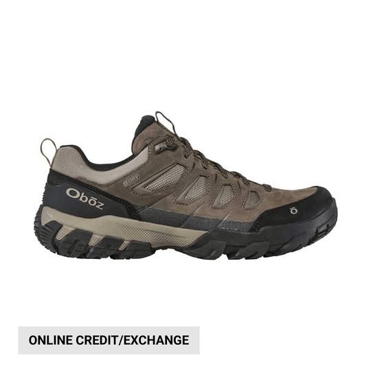 Brown and black low hiking shoe with mesh panels, laces, and rugged tread