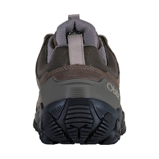 Brown and gray low hiking shoe shown from the heel, with mesh upper, pull tab, and rugged black outsole