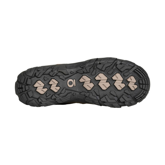 Black rugged hiking shoe outsole with tan traction lugs and deep tread