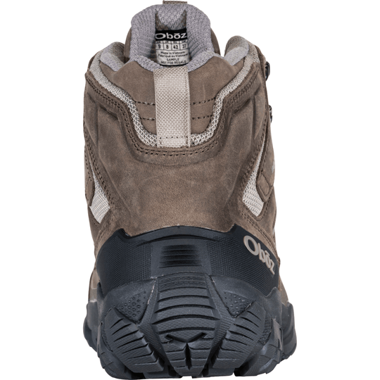 Brown hiking boot seen from the back with a padded collar, mesh panels, and a black lugged outsole