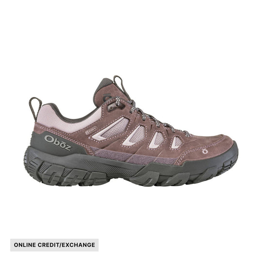 Brown low-top hiking shoe with mesh panels, thick tread, and ONLINE CREDIT/EXCHANGE label