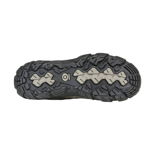 Black hiking shoe outsole with deep lugs and light gray tread inserts