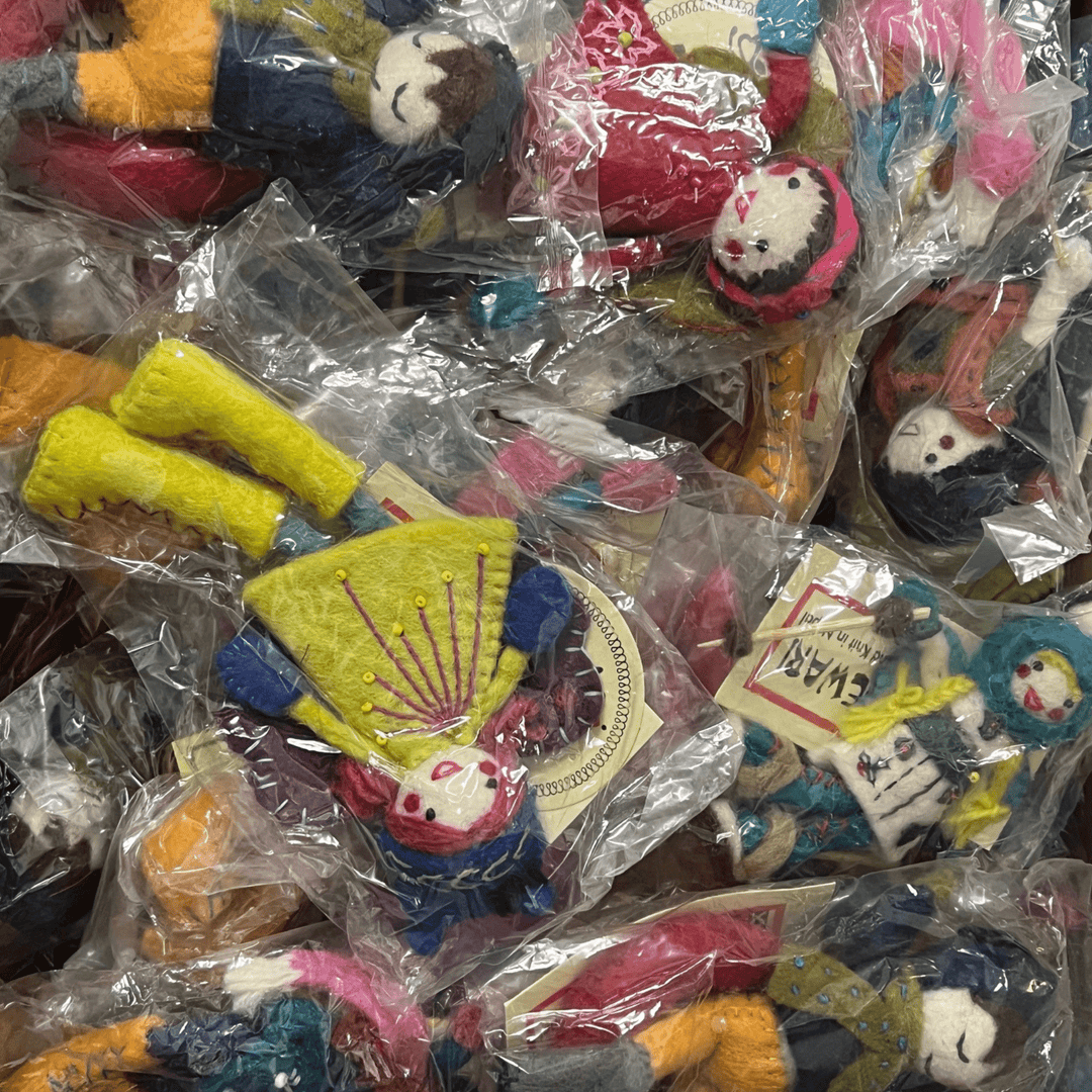 Clear plastic bags filled with small colorful felt plush charms and keychain-like figures