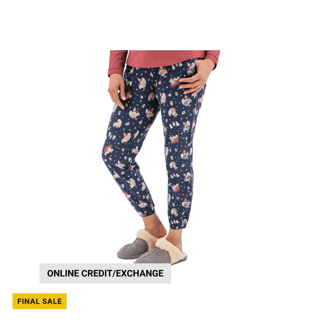 Navy pajama joggers with holiday character and snowflake print, shown with gray slippers