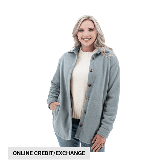 Light blue fleece shirt jacket with buttons, worn over a cream sweater