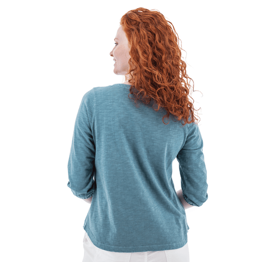 Woman modeling a blue long-sleeve top from the back