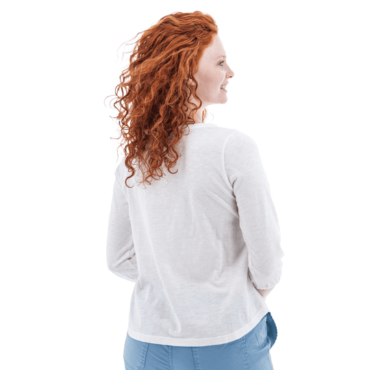 White long-sleeve top shown from the back on a woman with curly red hair