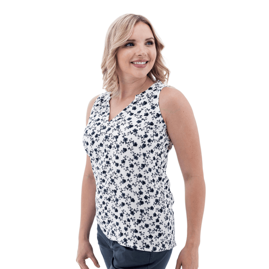 Sleeveless white floral top with navy print shown on a model