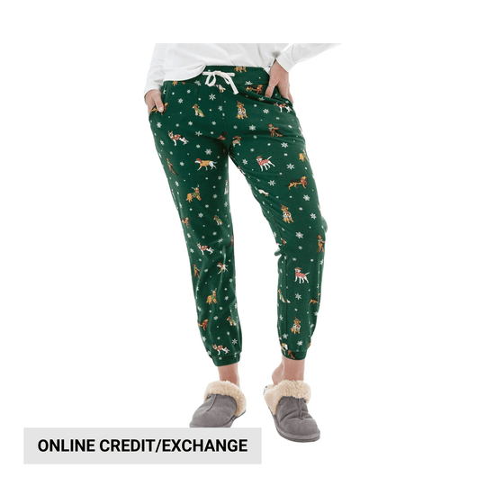 Green jogger pajama pants with dog and snowflake print, shown with gray slippers and an online credit/exchange label