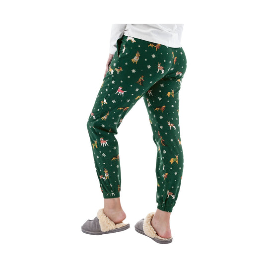 Green jogger pajama pants with allover dog and snowflake print, shown on a model wearing gray faux-fur slippers