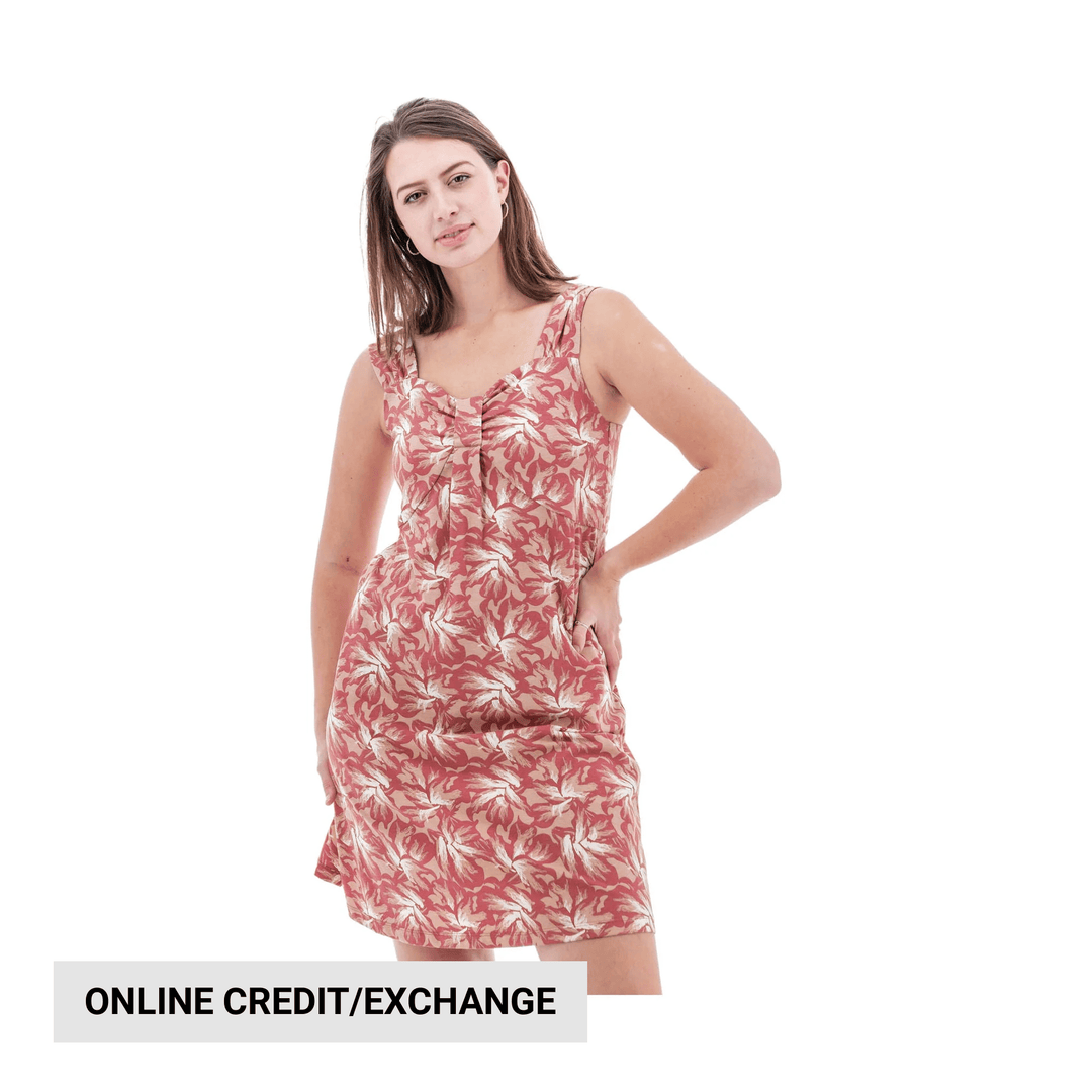 Pink floral sleeveless dress on a model with one hand on hip