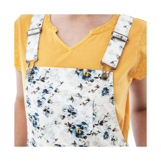 White floral-print overall shorts with adjustable straps over a yellow V-neck top