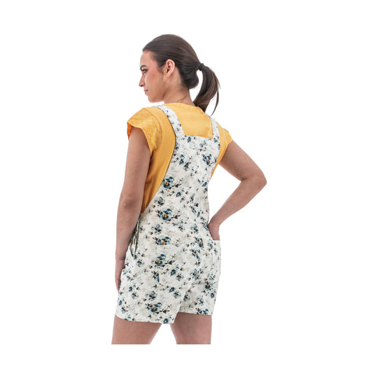 White floral overall shorts worn over a mustard yellow T-shirt, shown from the back