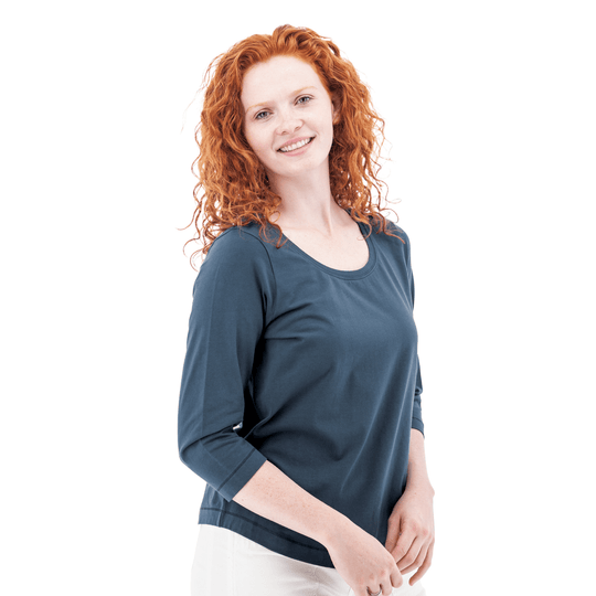 Woman wearing a slate blue three-quarter sleeve top with a scoop neckline