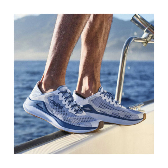 Blue and white athletic sneakers on a boat deck with rope laces and gum soles