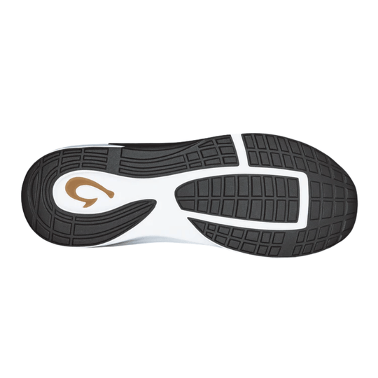 Black shoe outsole with white midsole and a tan logo detail