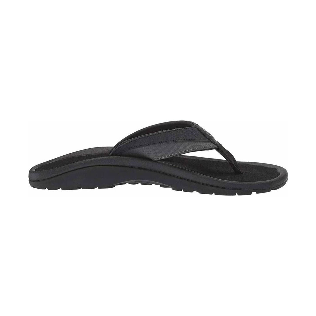 Black thong sandal with a textured strap and thick treaded sole, side view