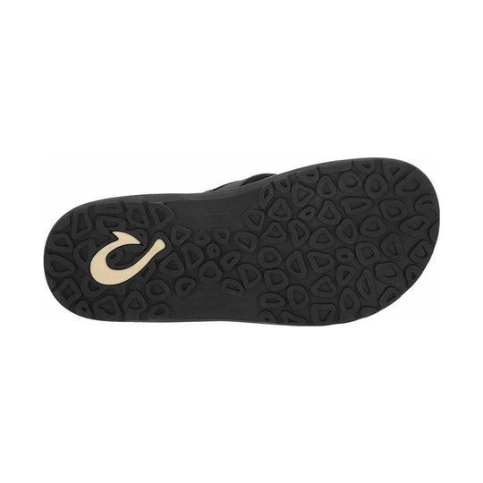 Black sandal outsole with textured tread and a cream logo