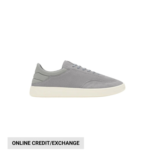 Gray low-top sneaker with white sole and lace-up closure