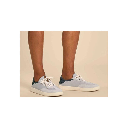 Light blue low-top sneakers with white laces and off-white soles
