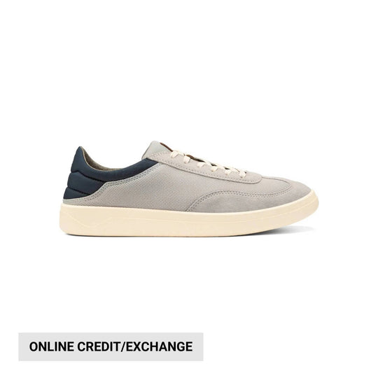 Low-profile gray sneaker with navy heel tab, white laces, and cream sole