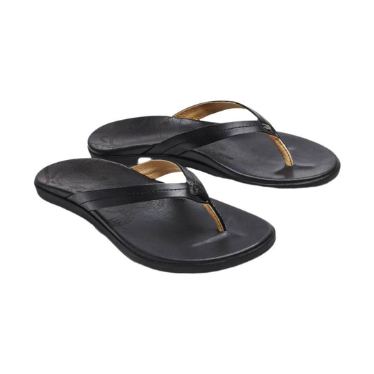 Black thong sandals with tan footbed accents, shown in a pair on a white background