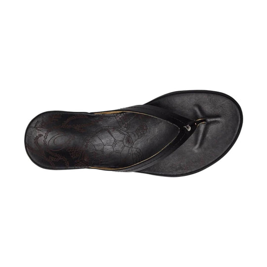 Black leather thong sandal with embossed floral pattern, shown from above