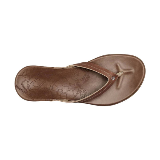 Tan leather thong sandal with a brown strap and embossed footbed pattern, viewed from above