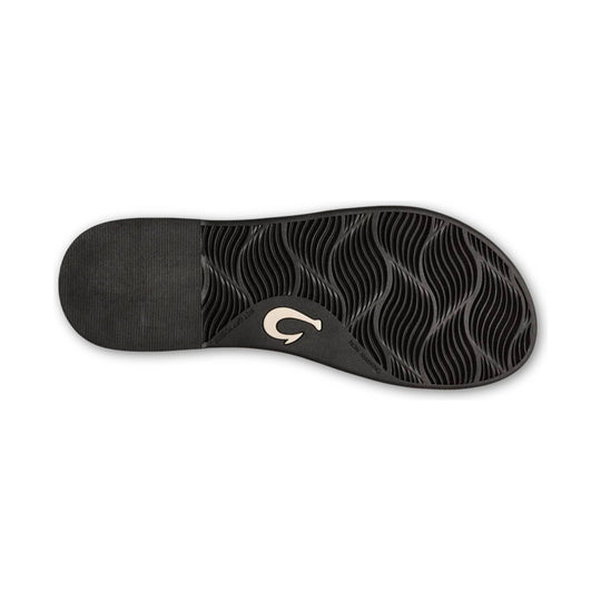 Black sandal outsole with wavy tread and a cream logo