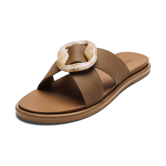Brown slide sandal with wide crisscross straps and a large marbled buckle detail