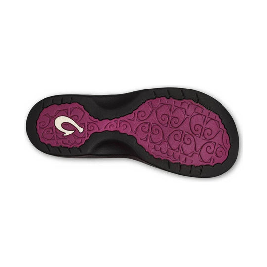 Black sandal outsole with magenta tread pattern and a white logo mark
