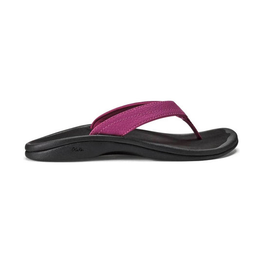 Black thong sandal with a magenta strap and textured footbed, side view