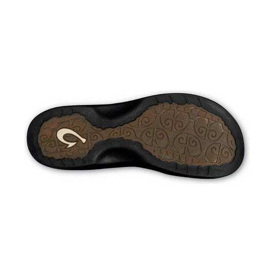 Black sandal outsole with brown textured tread and a white logo mark